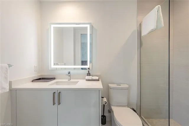 a bathroom with a sink toilet and mirror