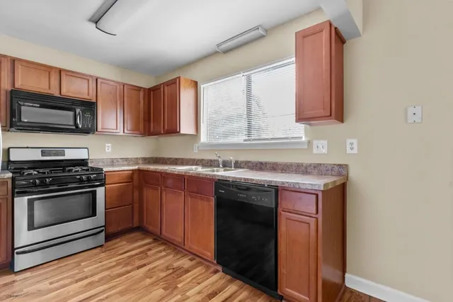 a kitchen with stainless steel appliances granite countertop a stove and a sink
