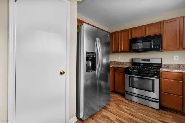 a kitchen with stainless steel appliances granite countertop a stove and a refrigerator