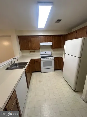 a kitchen with a refrigerator sink and stove