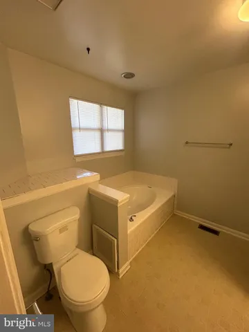 a bathroom with a sink a toilet and window
