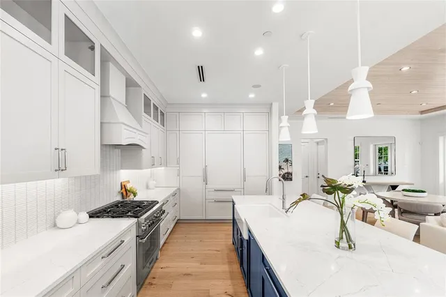 a stove top oven sitting inside of a kitchen