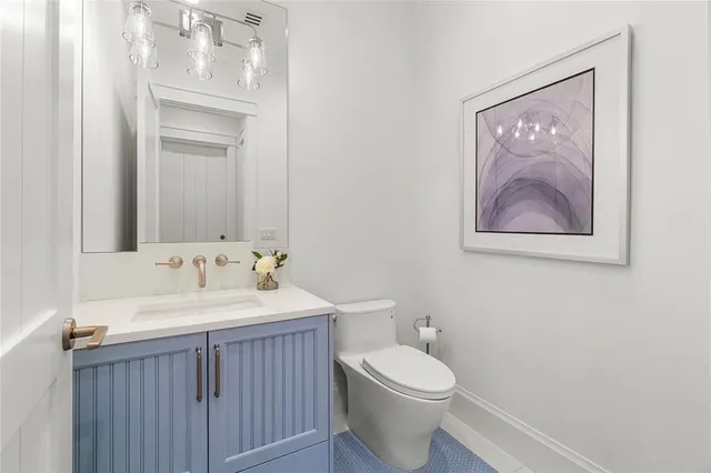 a dining room with furniture potted plants and wooden floor