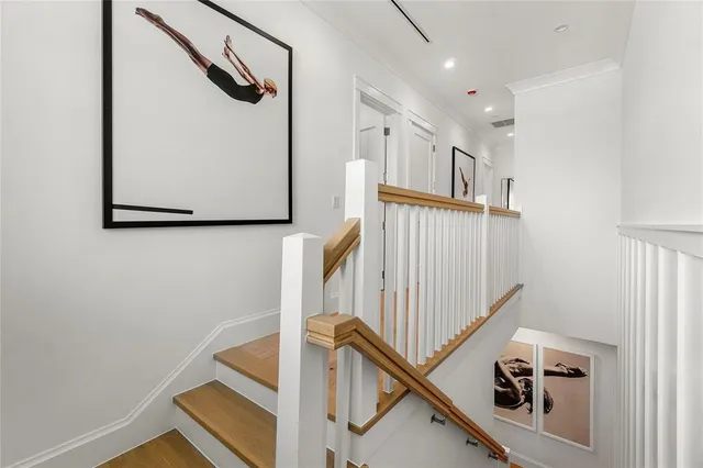 a view of a hallway with wooden floor