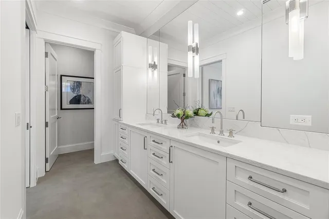 a bathroom with a double vanity sink and a mirror