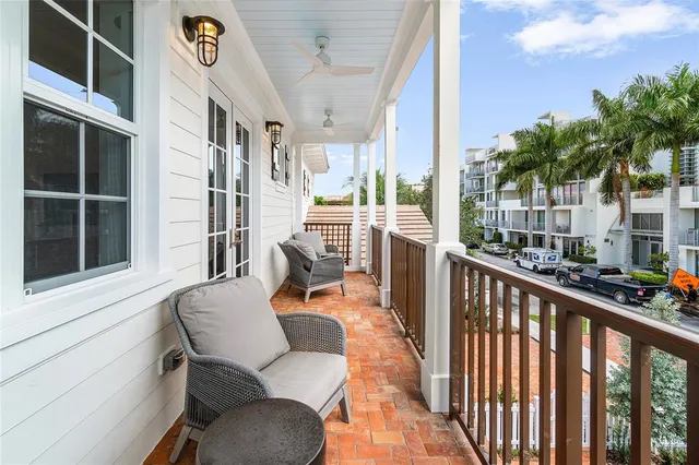 a front view of a house with swimming pool having outdoor seating
