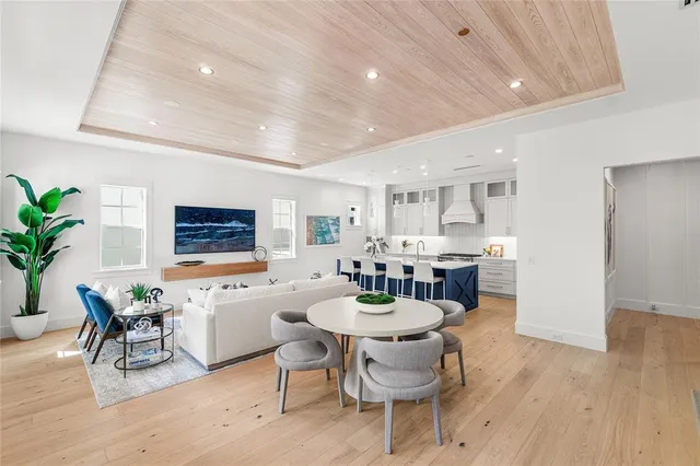 a living room with furniture and floor to ceiling windows