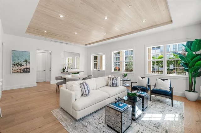 a living room with furniture kitchen view and a dining table