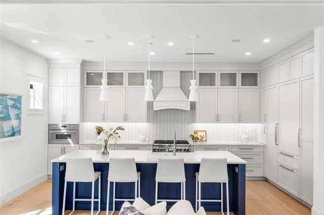 a kitchen with a dining table chairs sink and cabinets