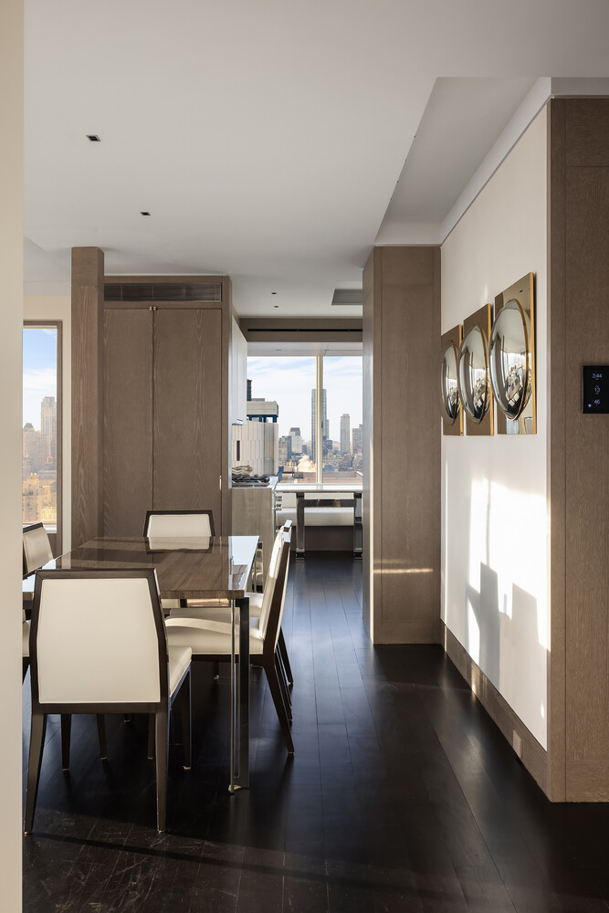 200 East 69th Street, Unit 31C Manhattan, NY 10021 - Photo 5 of 19 a dining room with furniture and wooden floor