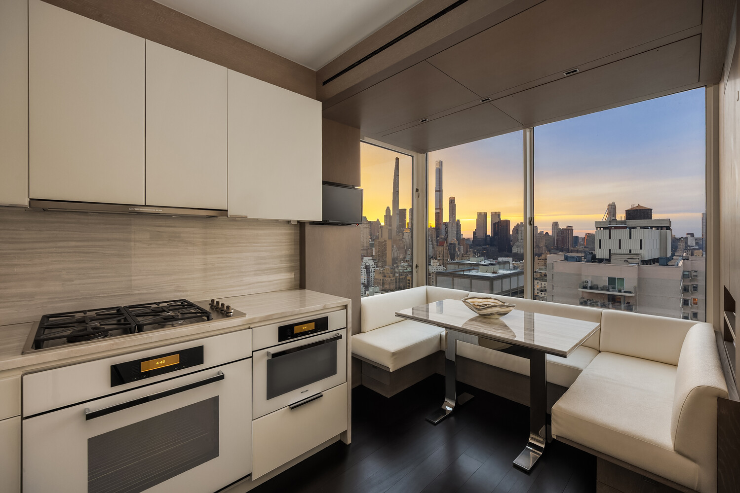 200 East 69th Street, Unit 31C Manhattan, NY 10021 - Photo 9 of 19 a kitchen with a white stove top oven and white cabinets