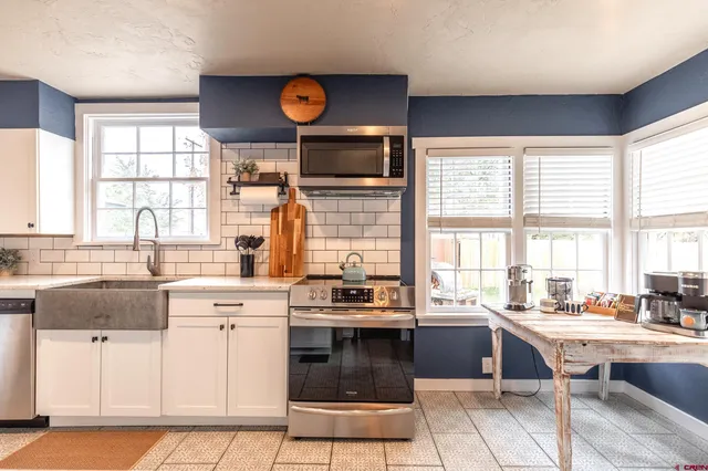 a kitchen with a stove a sink and a refrigerator