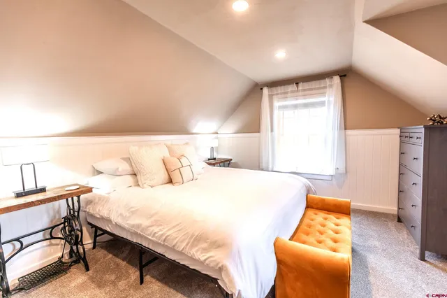 a bedroom with a bed and a chair