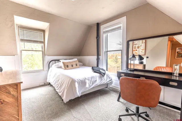 a bedroom with a bed and a large window