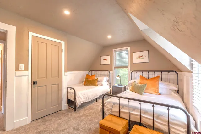 a bedroom with furniture and a lamp