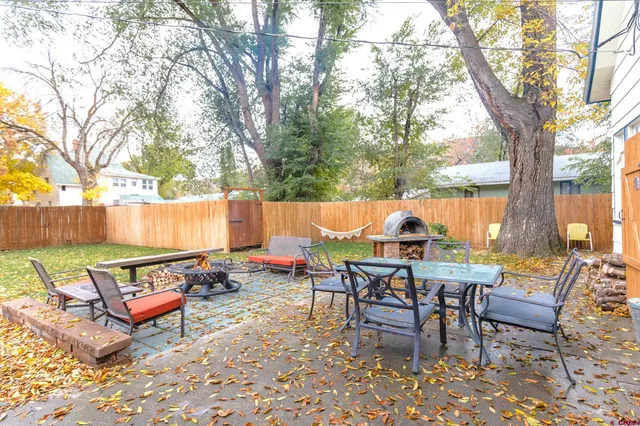 an outdoor sitting area with couch and outdoor seating