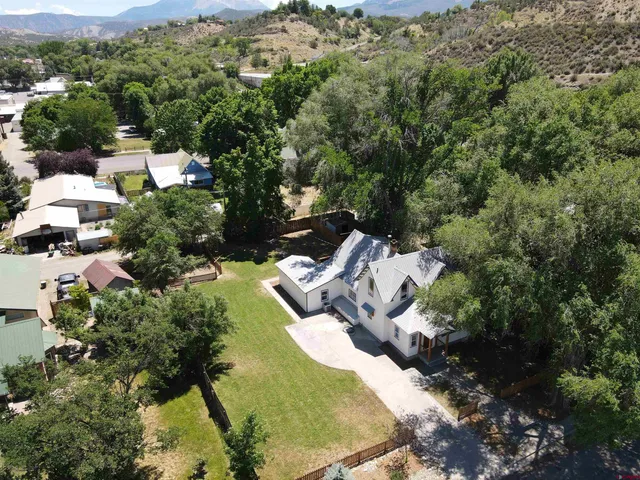 an aerial view of a house with a yard
