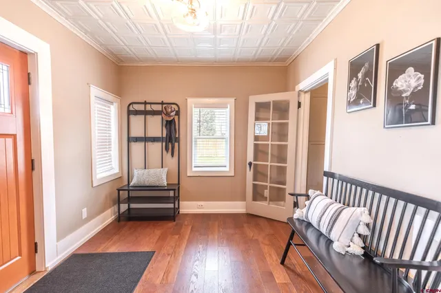a bedroom with furniture and wooden floor