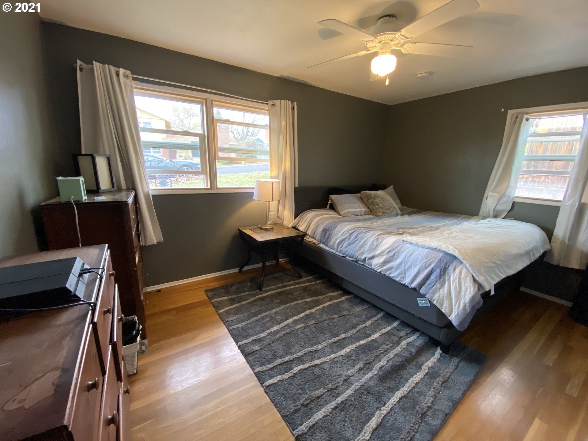 3216 Southwest Jay Avenue Pendleton, OR 97801 - Photo 23 of 32 a bedroom with a large bed chandelier and a window