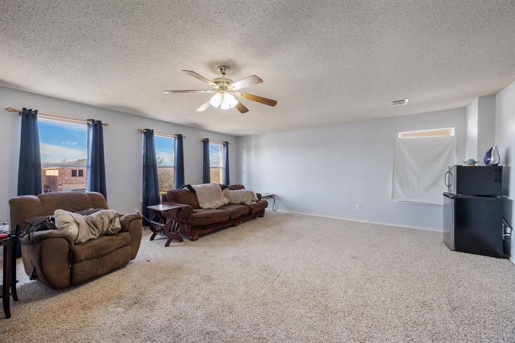 1609 Jester Court Little Elm, TX 75036 - Photo 20 of 34 a living room with furniture and a chandelier
