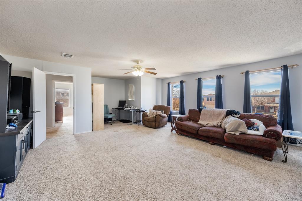 1609 Jester Court Little Elm, TX 75036 - Photo 21 of 34 a living room with furniture and a flat screen tv