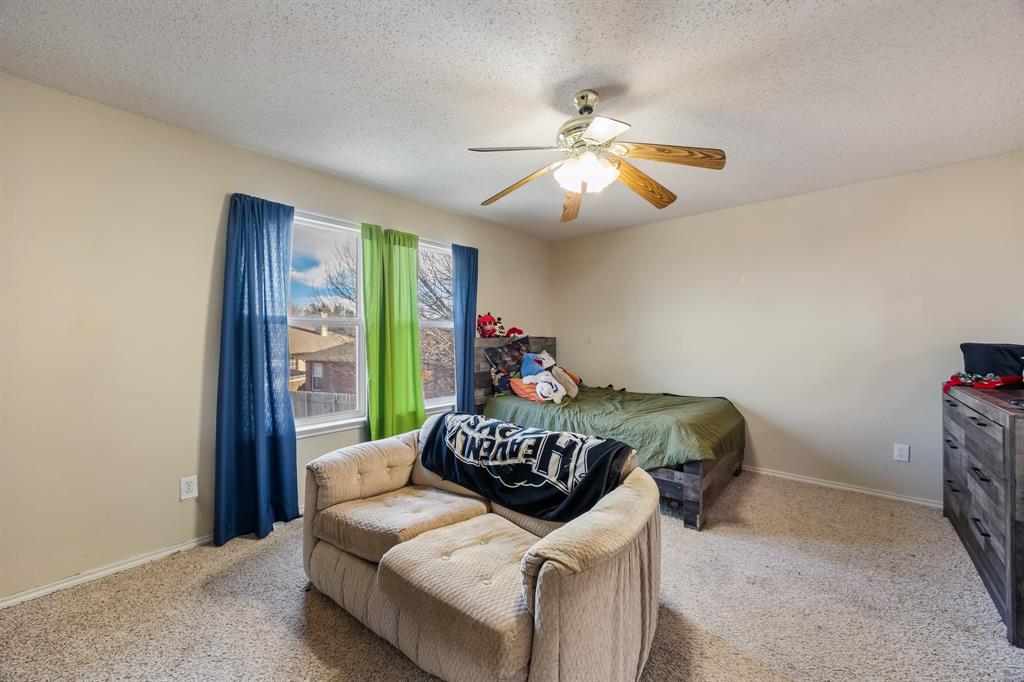 1609 Jester Court Little Elm, TX 75036 - Photo 25 of 34 a living room with furniture and a chandelier