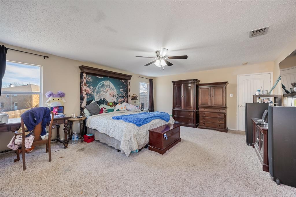 1609 Jester Court Little Elm, TX 75036 - Photo 27 of 34 a bed room with furniture and a chandelier
