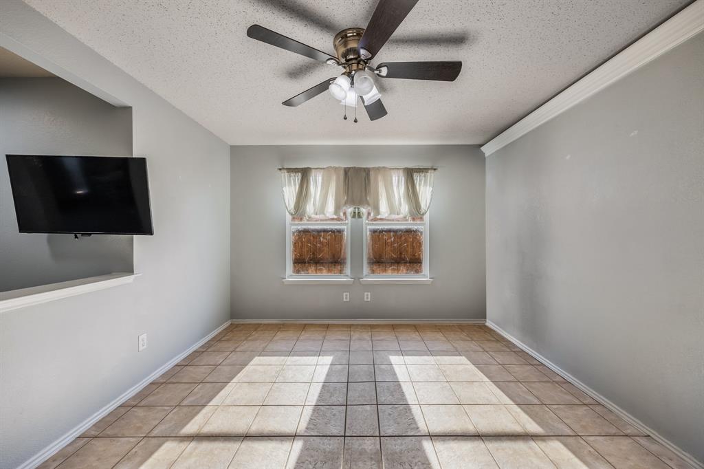 1609 Jester Court Little Elm, TX 75036 - Photo 7 of 34 a view of an empty room with a window and a flat screen tv