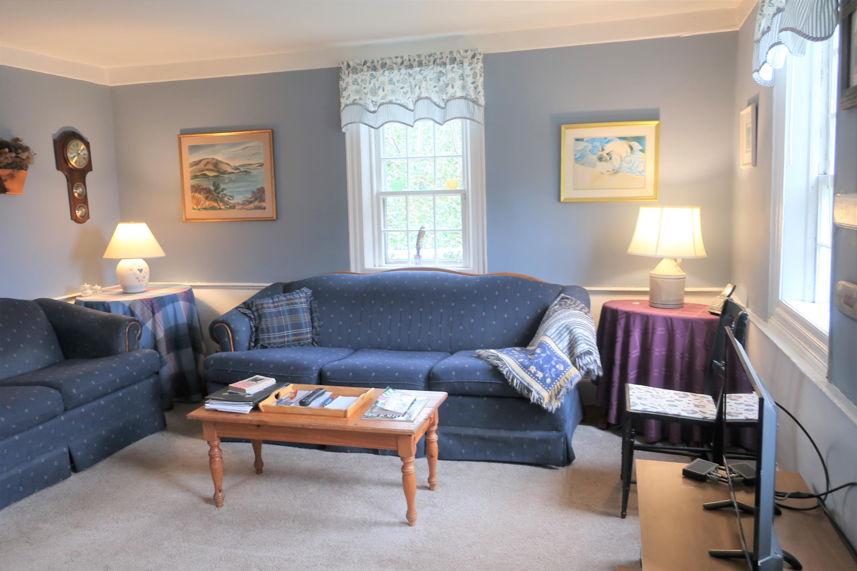 5 Meetinghouse Road Truro, MA 02666 - Photo 8 of 40 a living room with furniture and a large window