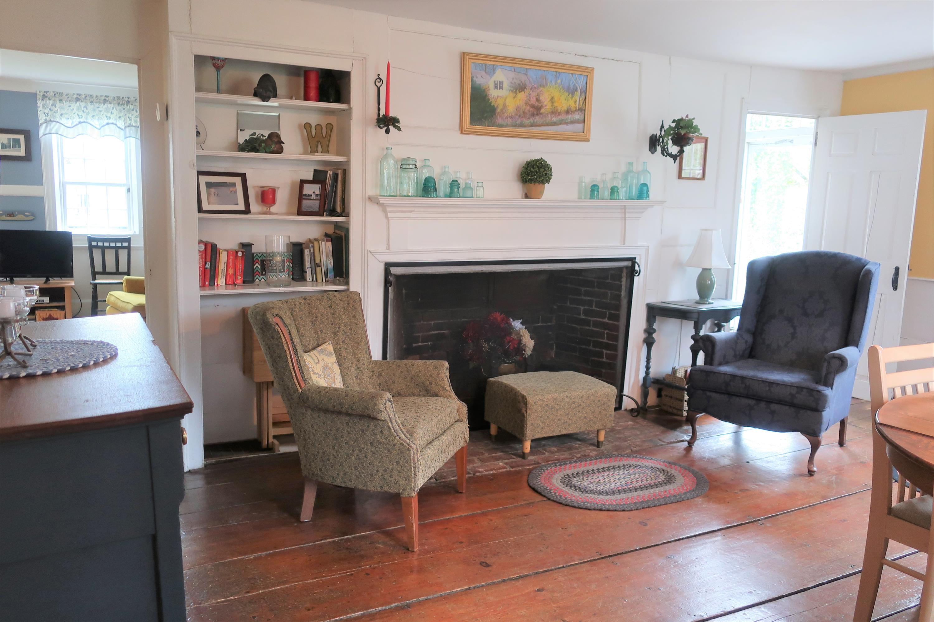 5 Meetinghouse Road Truro, MA 02666 - Photo 9 of 40 a living room with furniture and a fireplace
