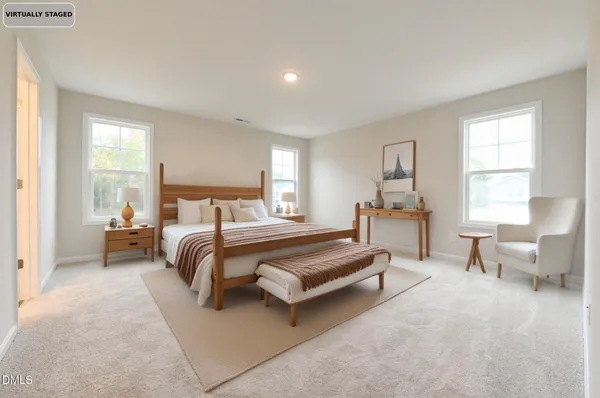 a spacious bedroom with a bed and a couch