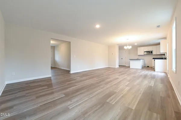 a view of a kitchen with wooden floor and a sink