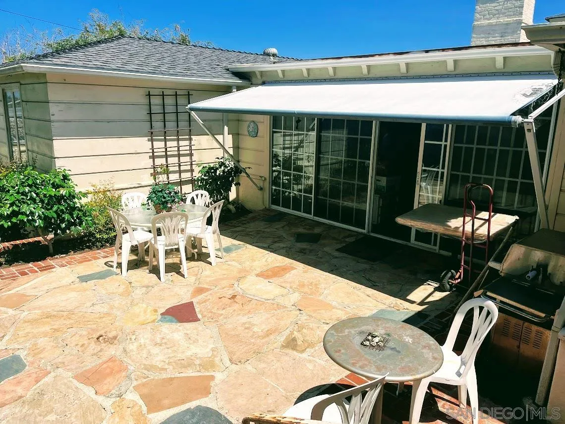 7976 Roseland Drive La Jolla, CA 92037 - Photo 4 of 7 a view of a patio with a table chairs and a backyard