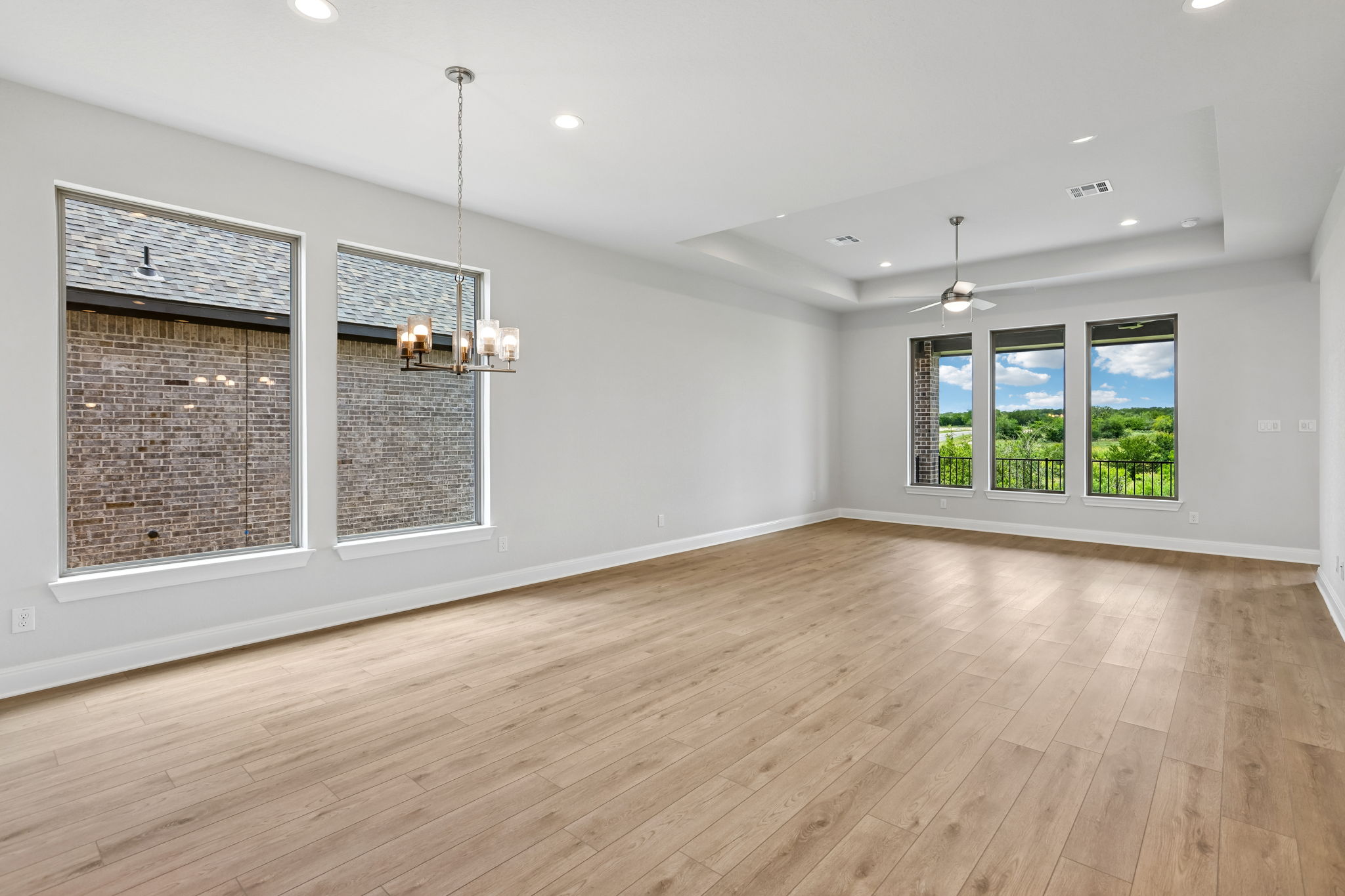 214 Prickly Poppy Loop Kyle, TX 78640 - Photo 13 of 38 an empty room with wooden floor and windows