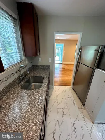a kitchen with a sink a stove and a refrigerator