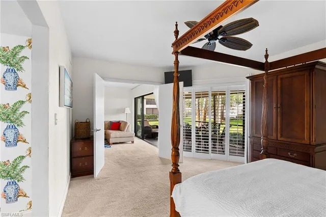 a bedroom with furniture and large windows