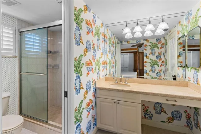 a bathroom with a sink a toilet and shower curtain
