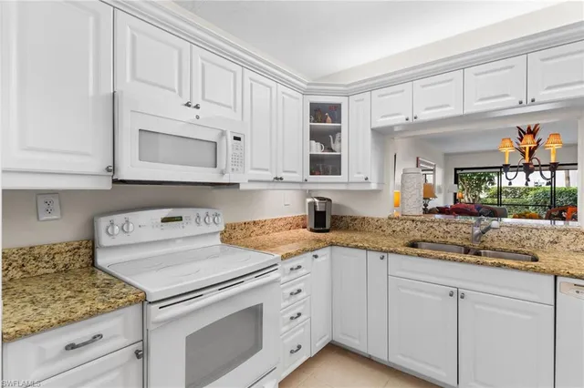 a kitchen with stainless steel appliances granite countertop a sink and cabinets