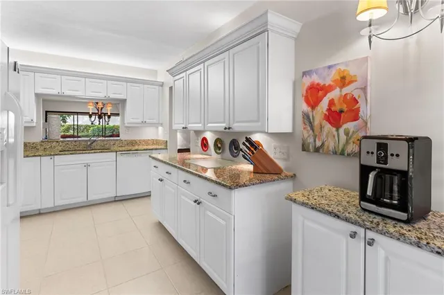 a kitchen with stainless steel appliances granite countertop a sink and cabinets