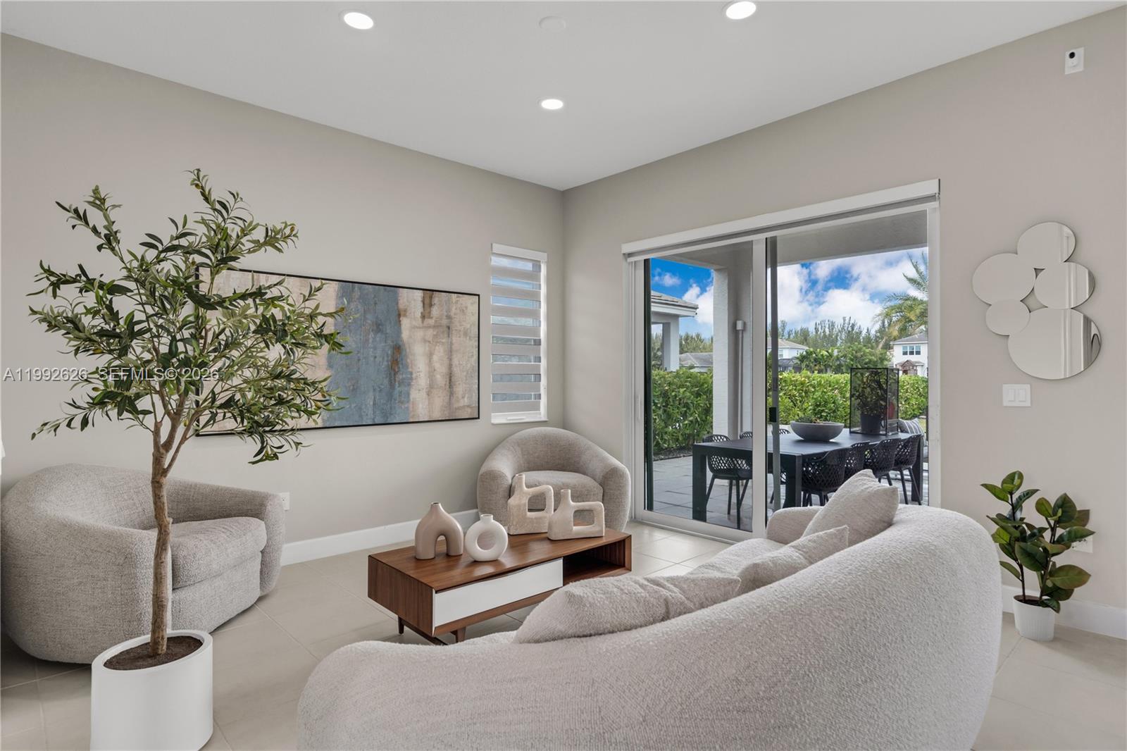15769 Hummingbird Lane Loxahatchee, FL 33470 - Photo 11 of 54 a living room with furniture and a large window