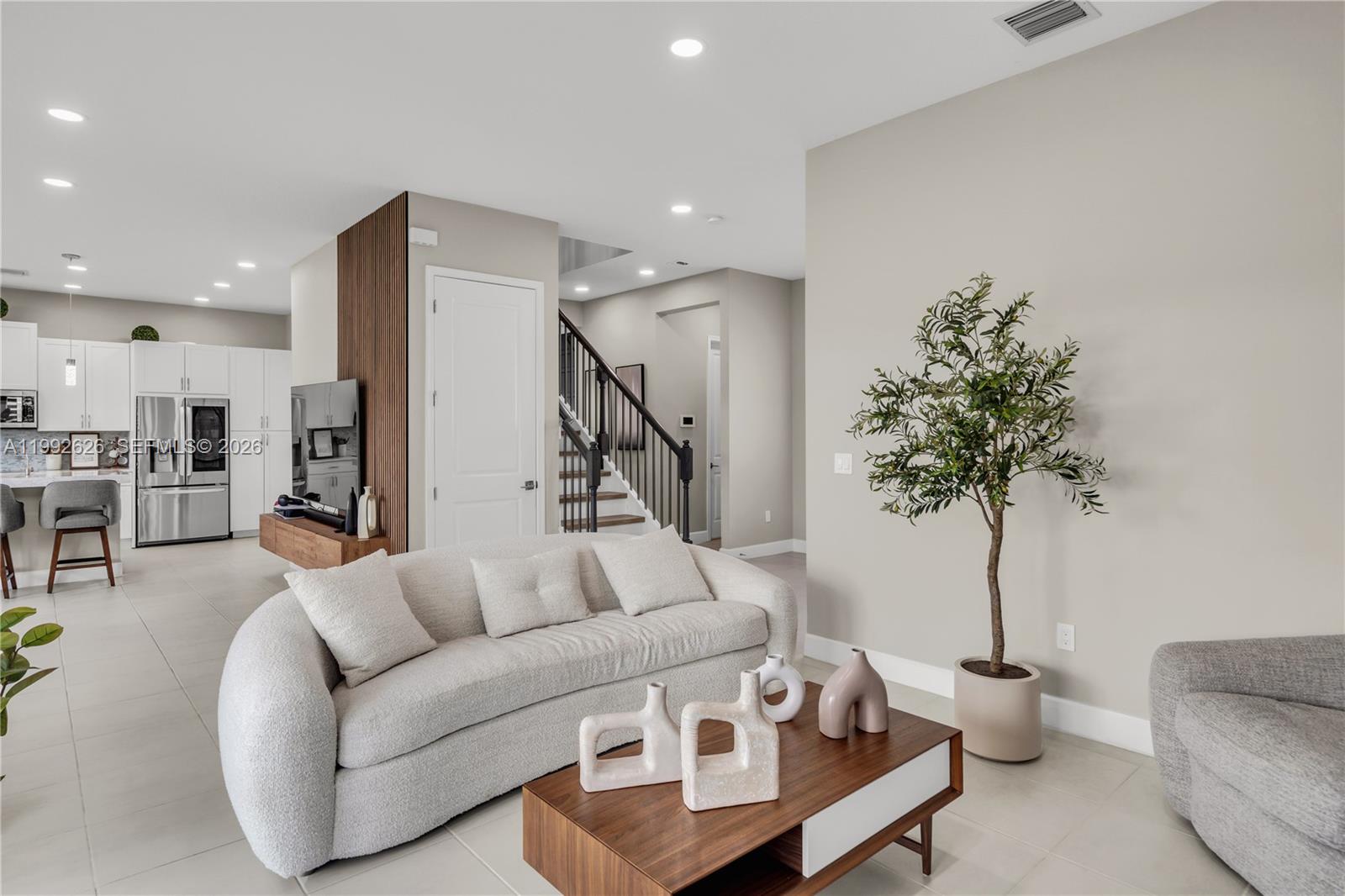 15769 Hummingbird Lane Loxahatchee, FL 33470 - Photo 12 of 54 a living room with furniture and a potted plant
