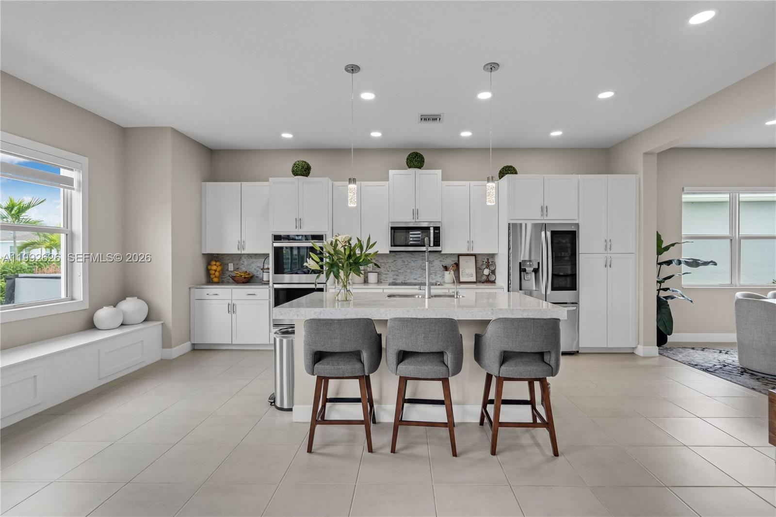 15769 Hummingbird Lane Loxahatchee, FL 33470 - Photo 13 of 54 a large kitchen with a table and chairs