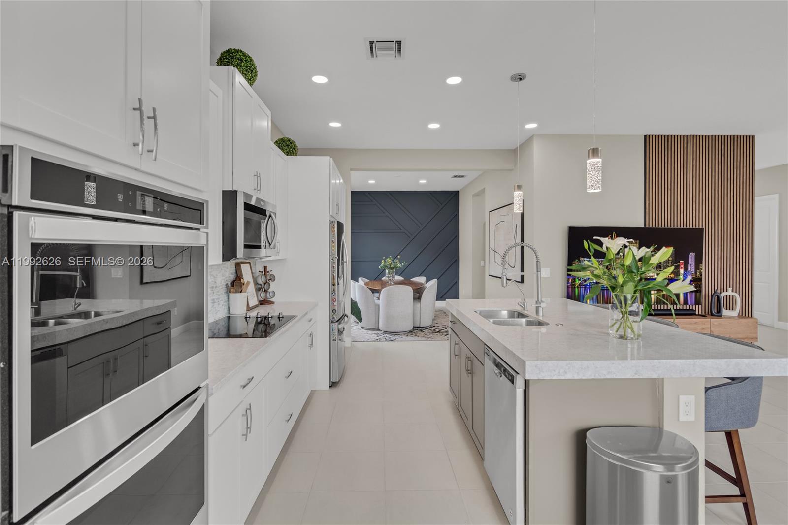 15769 Hummingbird Lane Loxahatchee, FL 33470 - Photo 14 of 54 a large kitchen with stainless steel appliances a sink and cabinets