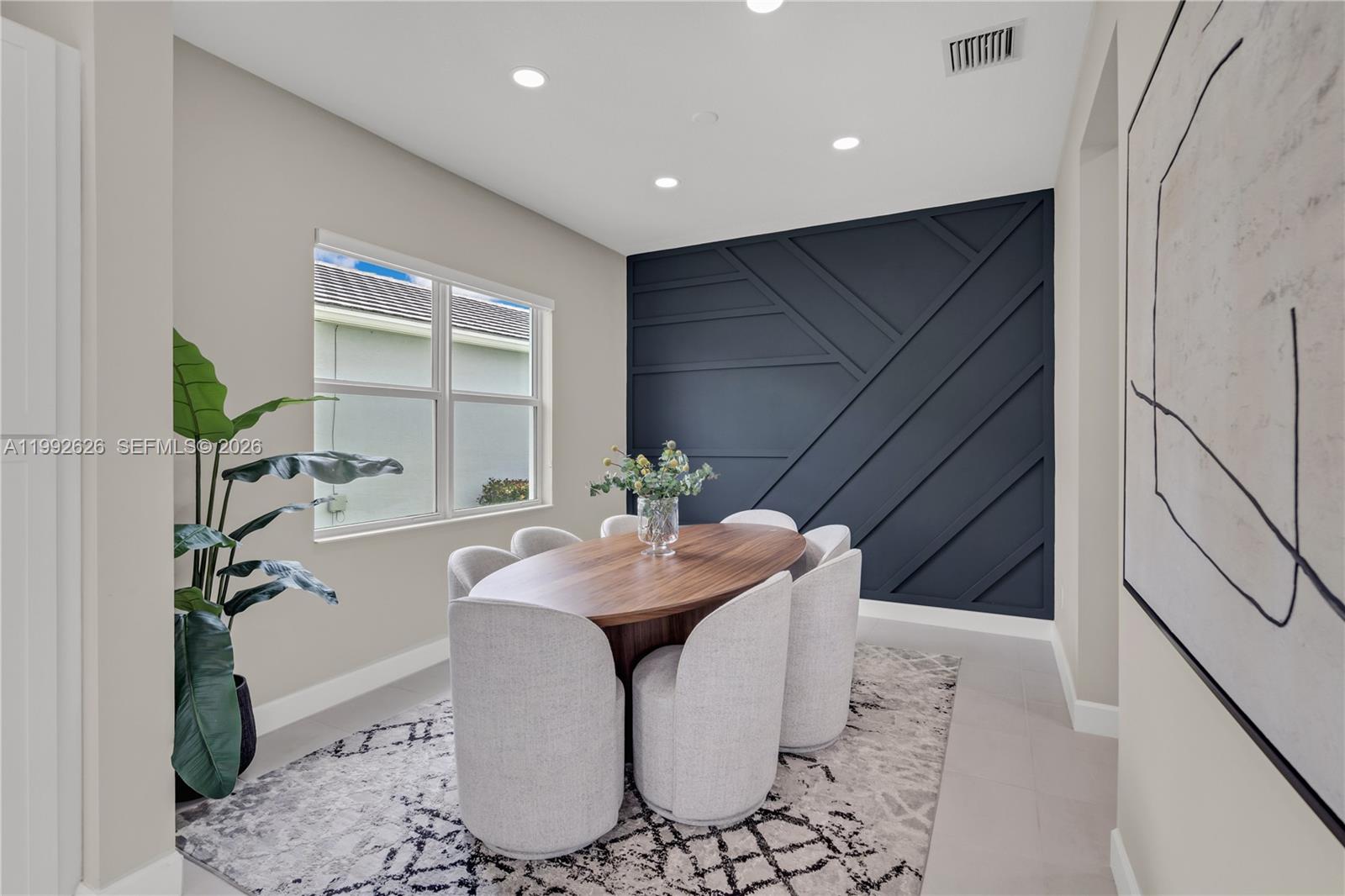 15769 Hummingbird Lane Loxahatchee, FL 33470 - Photo 16 of 54 a dining room with furniture and wooden floor