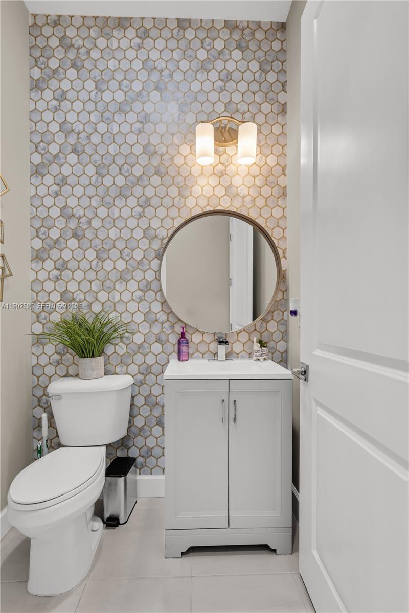 15769 Hummingbird Lane Loxahatchee, FL 33470 - Photo 18 of 54 a bathroom with a toilet sink and mirror