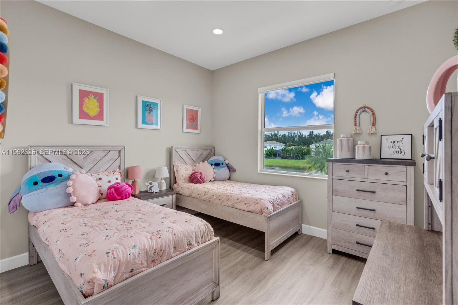 15769 Hummingbird Lane Loxahatchee, FL 33470 - Photo 21 of 54 a bedroom with two beds and a dresser