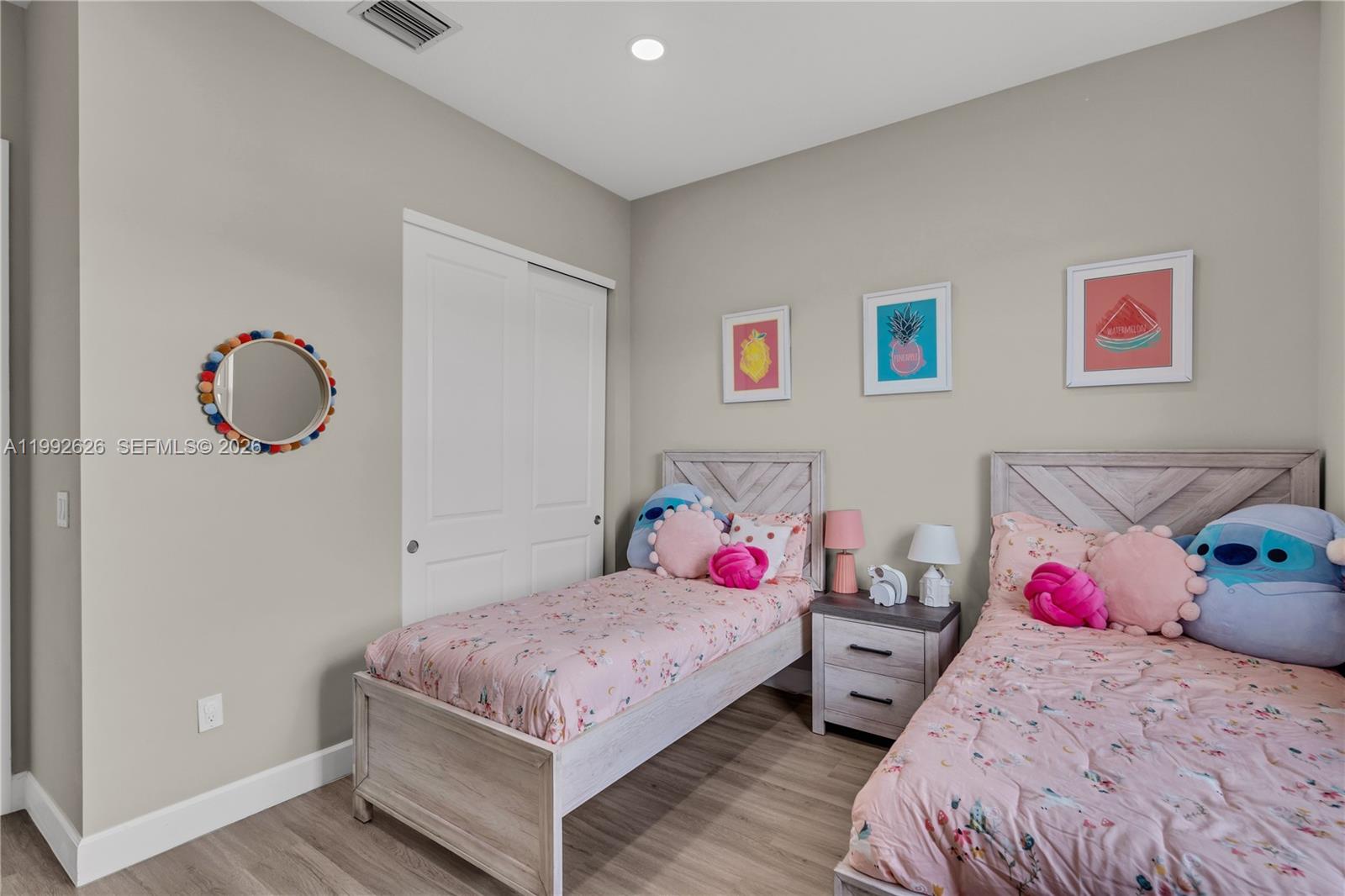 15769 Hummingbird Lane Loxahatchee, FL 33470 - Photo 22 of 54 a bedroom with two bed and a potted plant