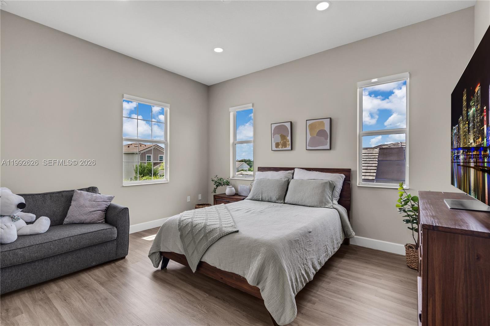 15769 Hummingbird Lane Loxahatchee, FL 33470 - Photo 23 of 54 a bedroom with a bed couch and a window