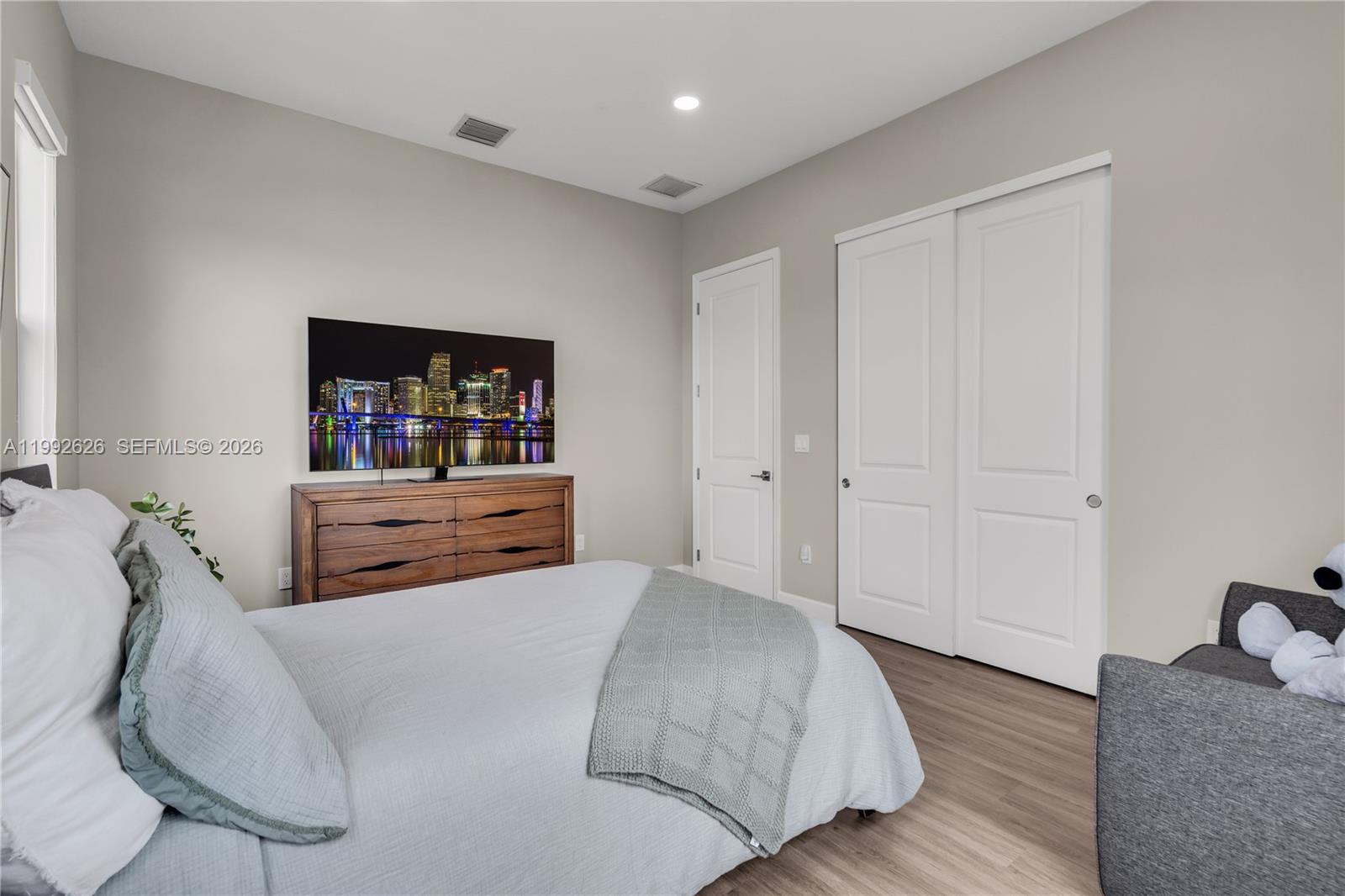 15769 Hummingbird Lane Loxahatchee, FL 33470 - Photo 24 of 54 a bedroom with a bed and dresser