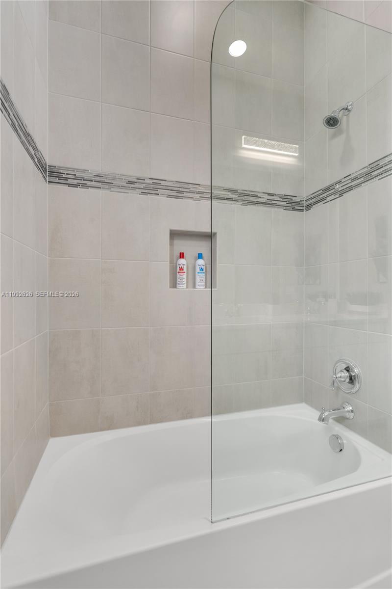 15769 Hummingbird Lane Loxahatchee, FL 33470 - Photo 26 of 54 a bathroom with a bathtub and a shower